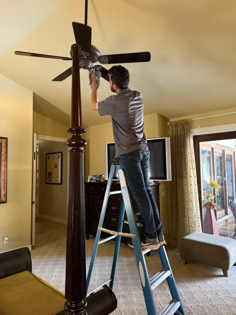 Ceiling fan dusting during a deep cleaning