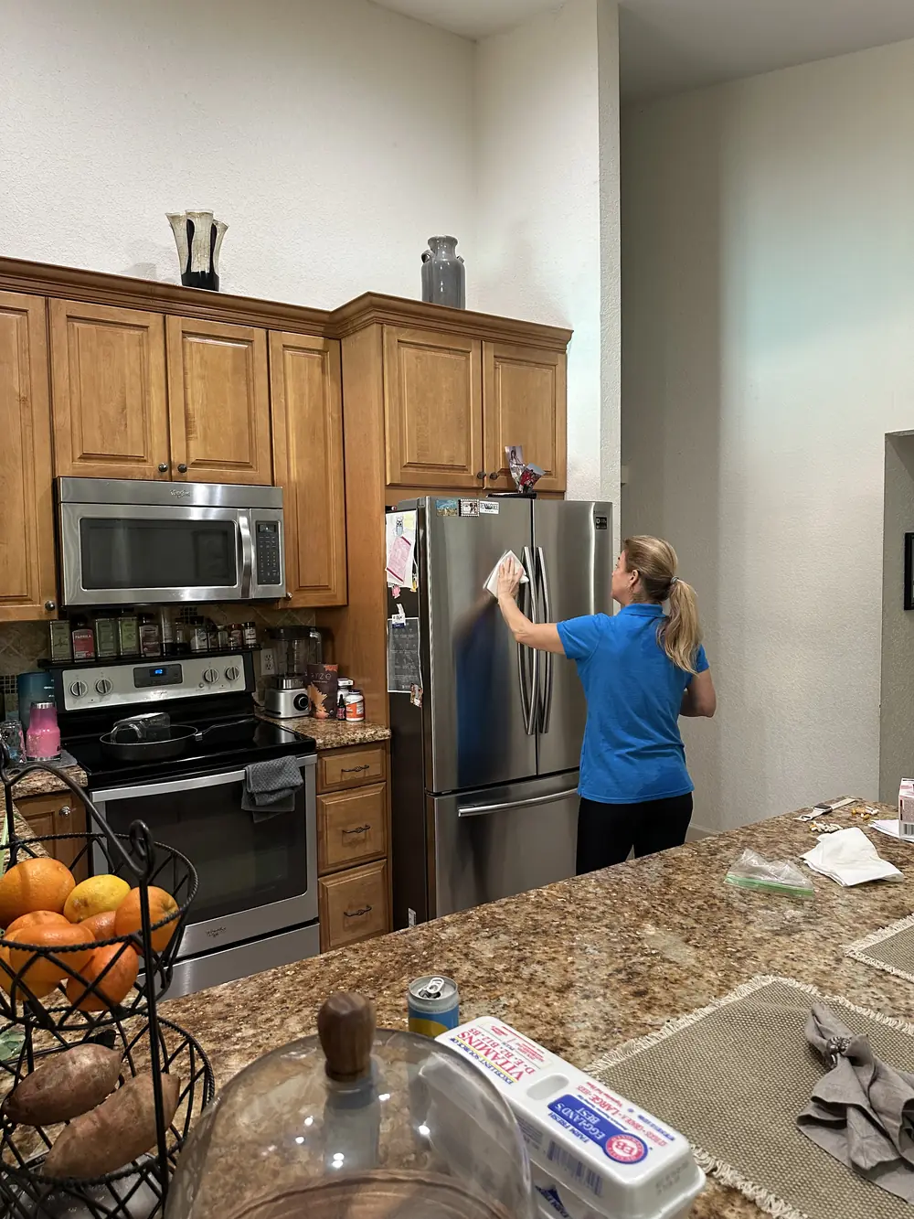 Professional cleaner detailing kitchen appliances