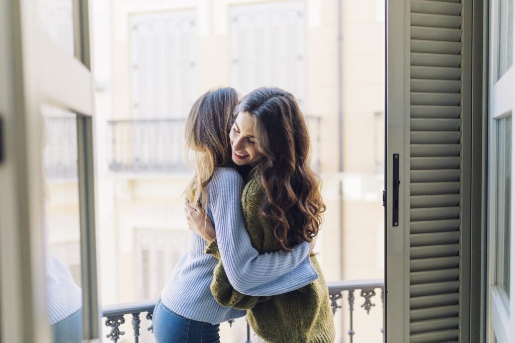 Two friends greeting each other at home in South Florida